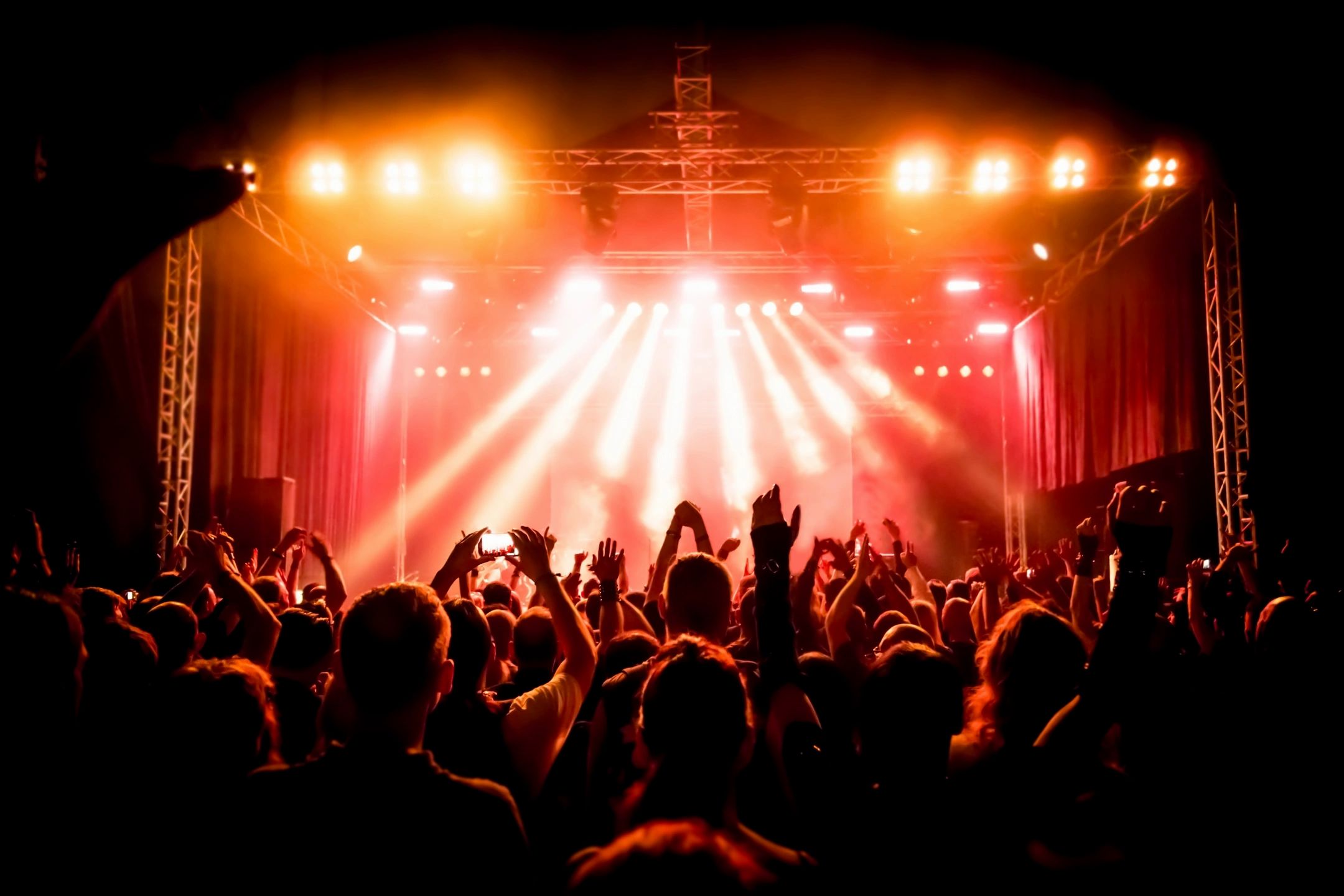 Concert crowd with dramatic stage lighting